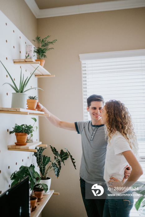 Happy Couple looking at indoor potted plants