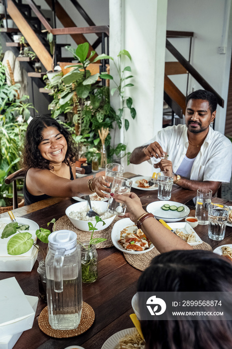 Group of friends sharing a meal together at home