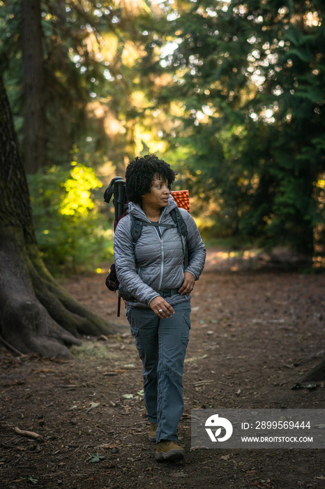 U.S. Army female soldier putting in the miles with an early morning hike in the NorthWest.