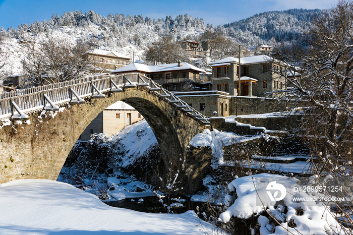 View of the traditional stone bridge in Vovousa village in Epirus, Greece in winter