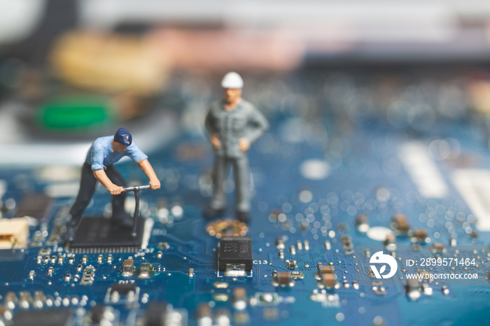 Miniature people : Worker team of engineers repairing keyboard computer laptop