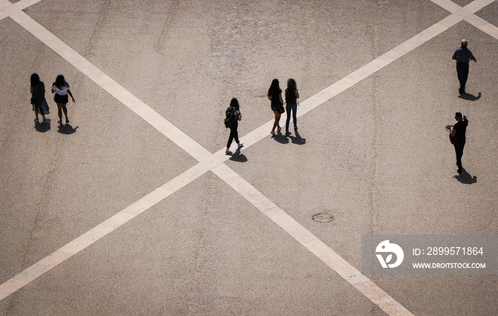 Aerial view of a group of people walking in a square in the city of lisbon in Portugal