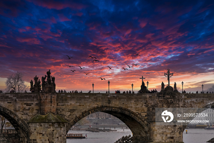 Prague’s Charles bridge with a dramatic sky in the background