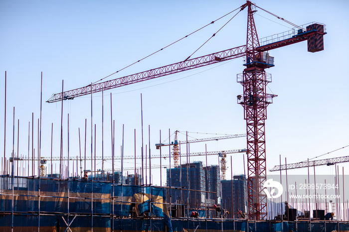 Construction crane tower on blue sky background.