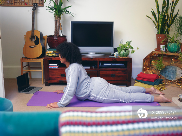 Woman practicing yoga at home