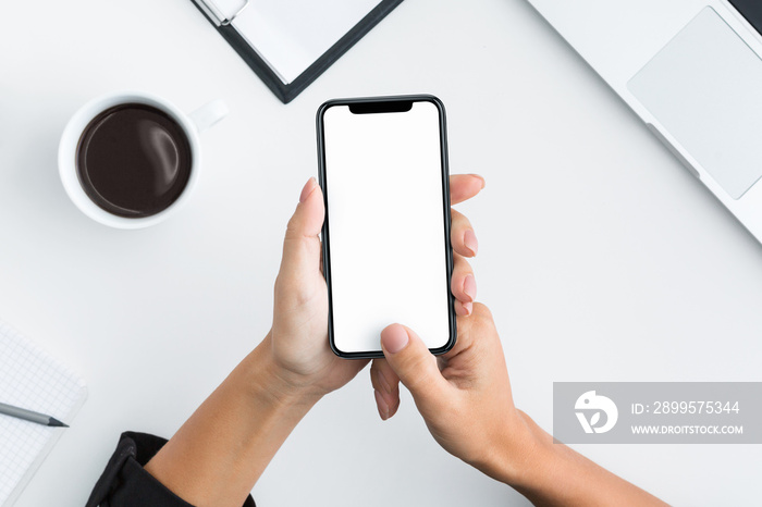 Hand using smartphone on white wooden background