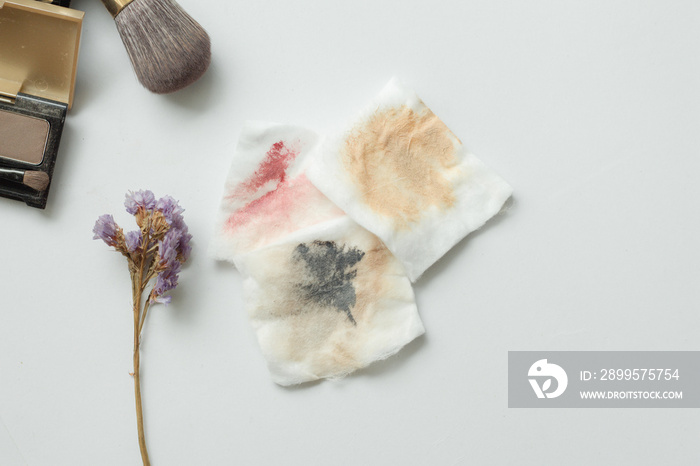 Top view of dirty cotton pads with make up on white background. accessories to make up removing.