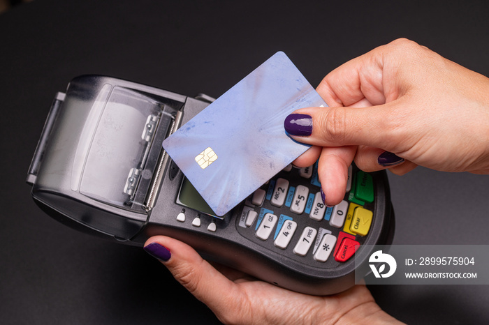 POS terminal, Payment Machine with credit card on black background.