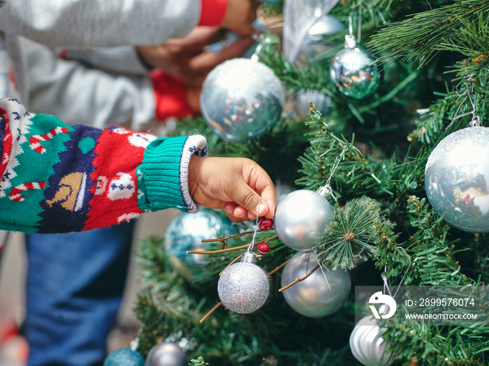 Father and sons decorating Christmas tree