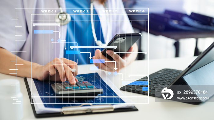 Project manager working and update tasks with Gantt chart scheduling diagram at hospital .success smart medical doctor working with smart medical doctor as concept..