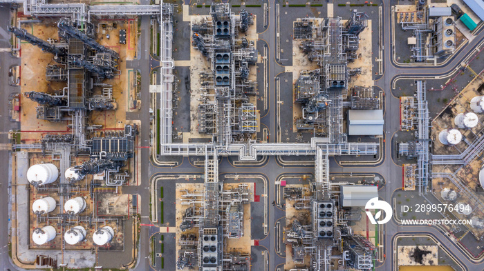 Oil refinery plant at industrial zone, Aerial view oil and gas business petrochemical industrial, Oil refinery factory white oil storage tank and pipeline steel, Ecosystem and healthy environment.