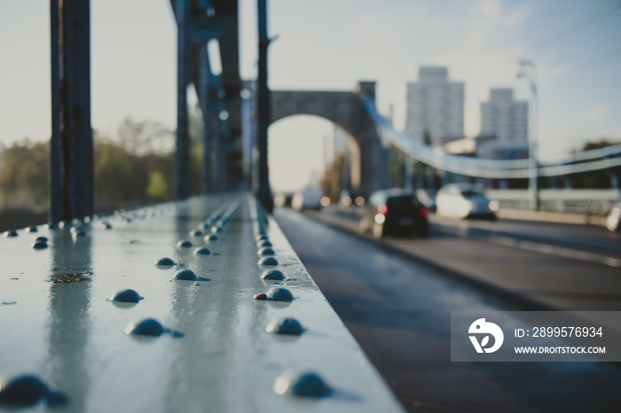 rivet as a detail of an old suspension bridge and city road in perspective