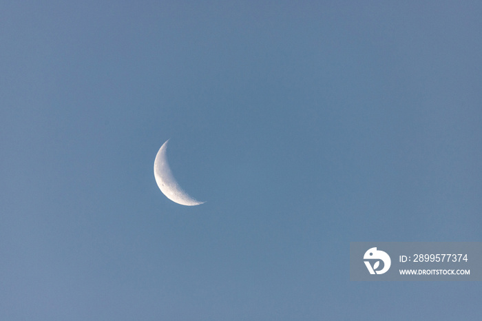 blue sky and descending moon