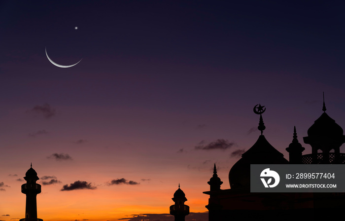 Silhouette dome mosques on sunset sky background in the evening with crescent moon