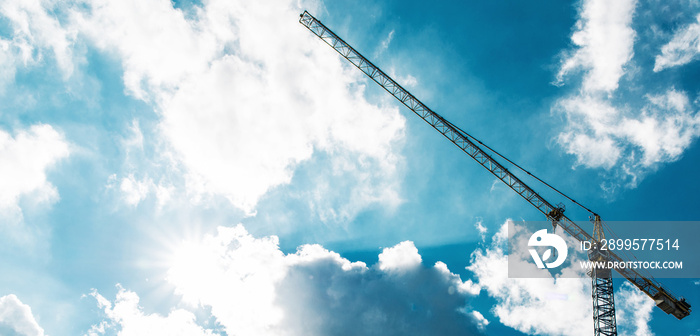 High crane at blue sky with clouds as background.