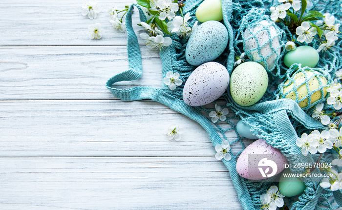 String bag with Easter eggs and spring blossom