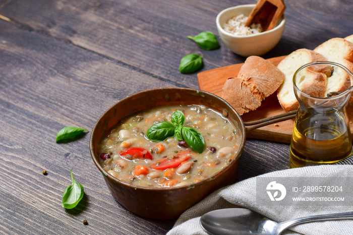 Traditional Italian dish  zuppa Toscana  from Tuscany ( Florence ) soup with different types of beans, carrots and vegetables. Vegan recipe. autumn winter food menu