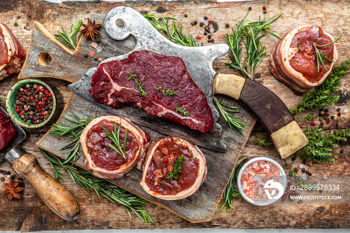 Variety of raw black angus prime meat steaks beef rump steak, Tenderloin fillet mignon for grilling on old meat cleaver on dark background. top view