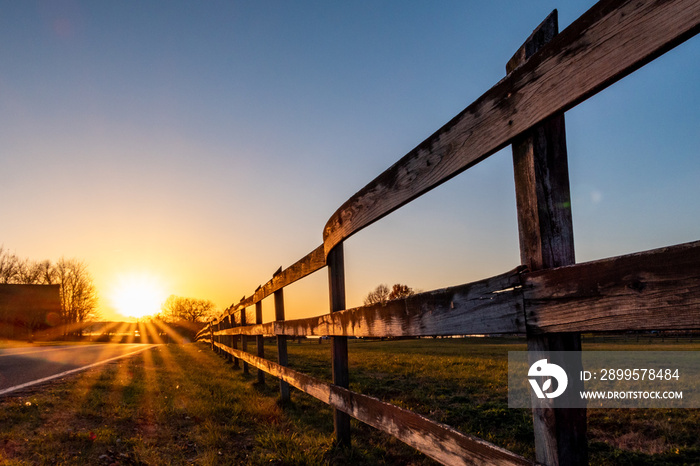 Broomes Island, Maryland USA Sunset over the Patuxent river and field with fences.