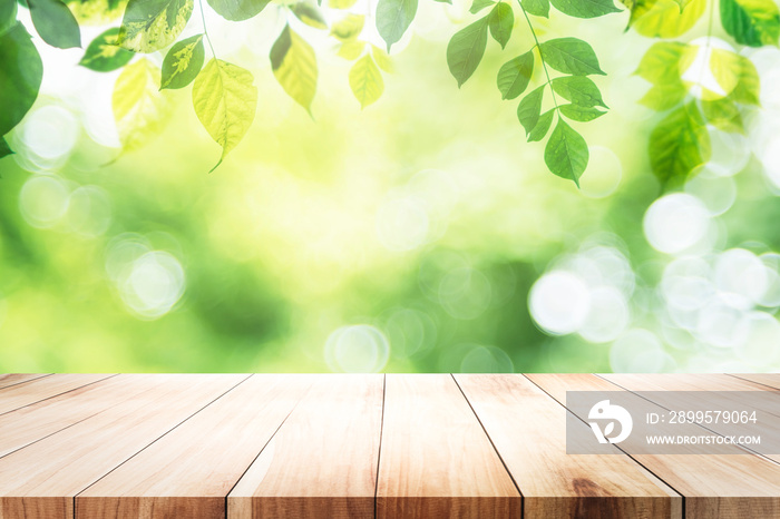 Empty table for present product with green bokeh background.