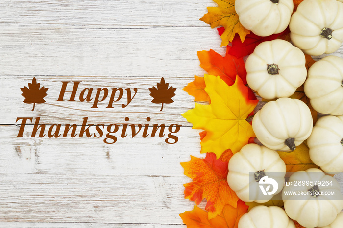 Happy Thanksgiving greeting white pumpkins with fall leaves