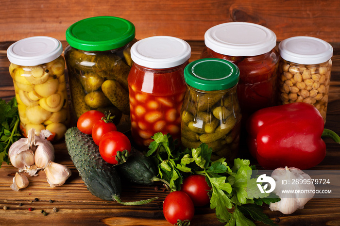 homemade canned vegetables on wooden background