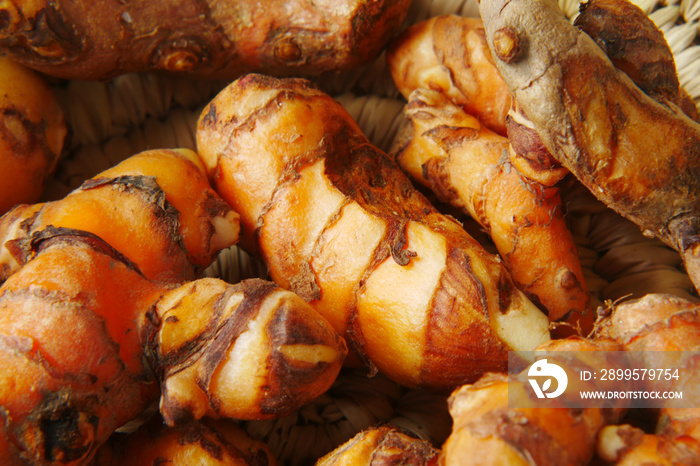 detail shot of turmeric root in bowl on table ,