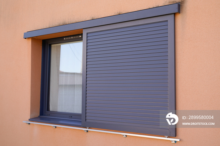 home windows with modern sliding shutters in house facade