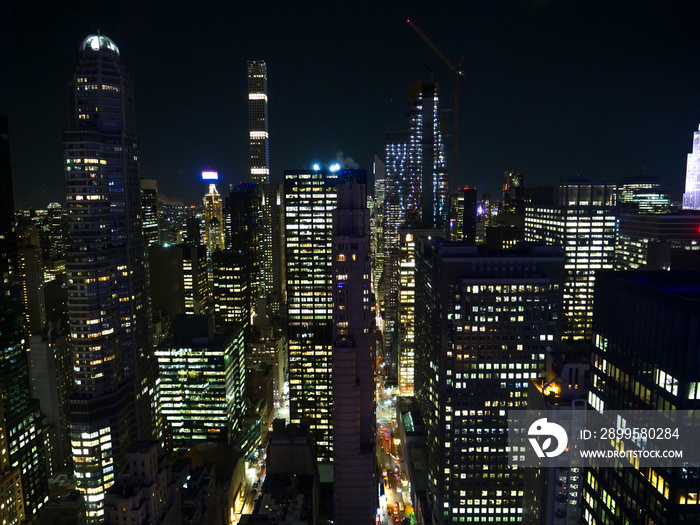 Picturesque view of the lit up modern skyscrapers on a dark night in New York.