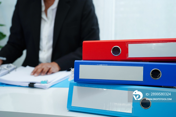 Stack of binder file folder on table in business modern office..on wooden desk in large modern office