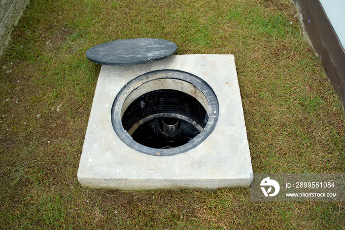 A hole of grease trap with the drain system around the house.