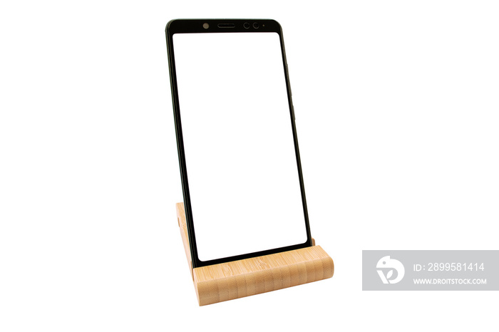 Wooden stand for smartphone isolated. Modern Mockup of a mobile phone with a white display. Environmental stands for fixing smartphones. Copy space.