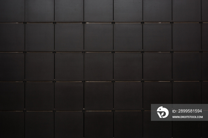 Black tile wall seamless background and texture