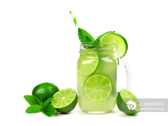 Limeade in a mason jar glass with fruit, mint and straw isolated on a white background