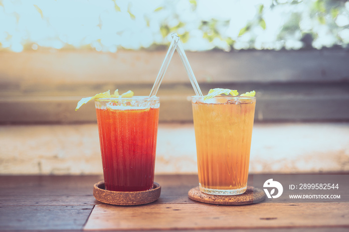 summer drink with ice put on wood table in vintage coffee shop