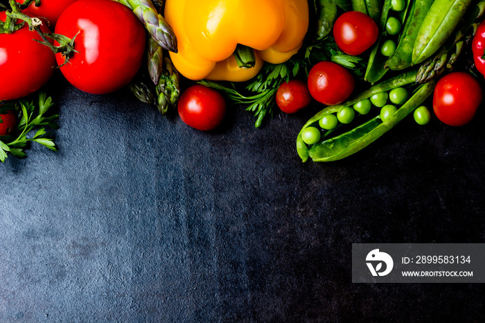 Food background. Fresh vegetables on black. Top view