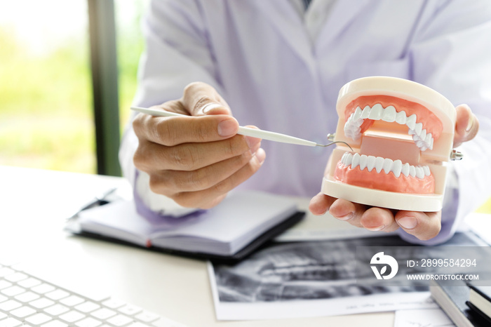 dentist work on the table with Denture and teeth x-ray