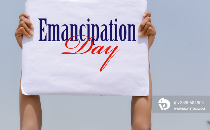 Emancipation Day with banner in hand in sky background