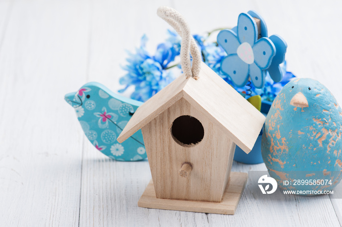 blue flowers, toy birds and birdhouse