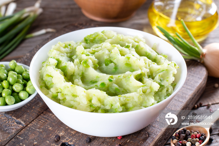 Mashed green peas and potatoes in a bowl on a table