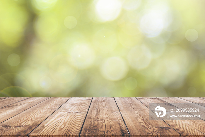 Wooden plank with natural green bokeh background