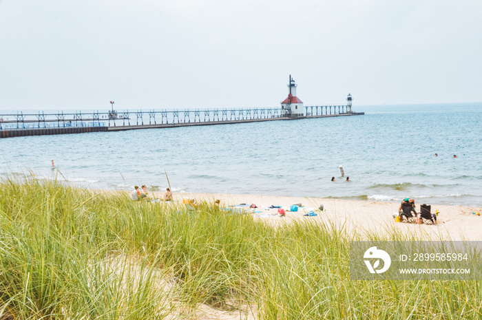 Lighthouse along sandy beach in Michigan.