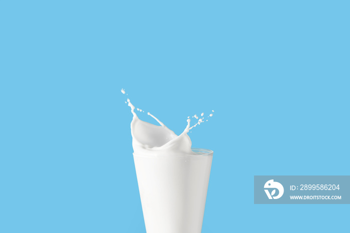 Glass of tasty milk with splashes on color background