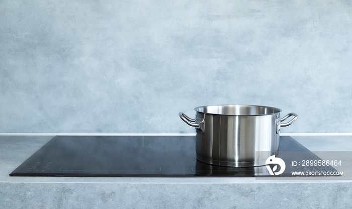 Steel pot on induction cooker.