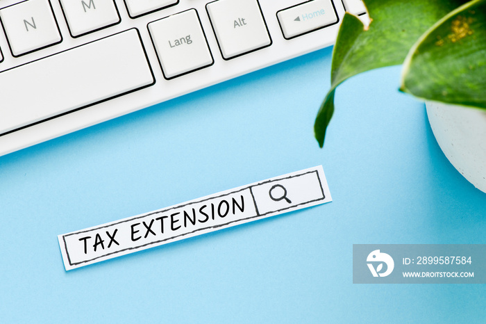 Tax extension text concept. Search line on blue background.