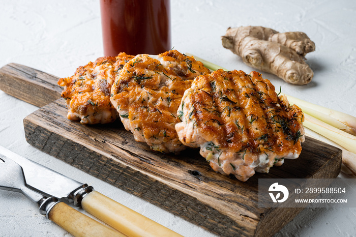 Grilled quick asian salmon cutlets, on white textured background