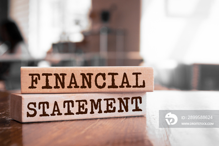 Wooden blocks with words ’Financial statement’.