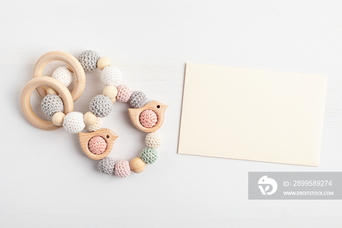 Eco friendly organic newborn teethers and empty card mockup. Template for baby shower invitation