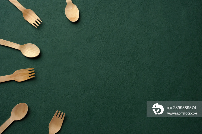 Plastic free set bamboo spoon and fork on dark green background.Zero waste disposable kitchen ware