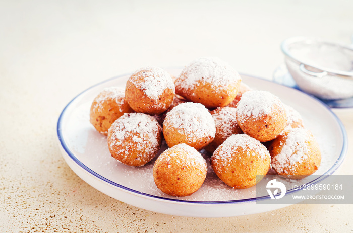 Castagnoli- italian fritters in carnival on white plate.